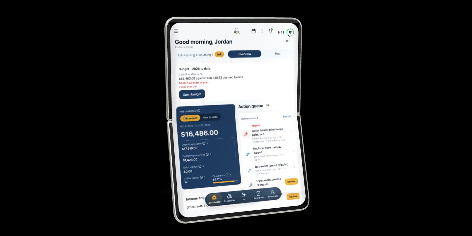 KeyRing on an open iPhone Duo held upright: Home with the greeting, net cash flow and the Action queue, across both halves of the display
